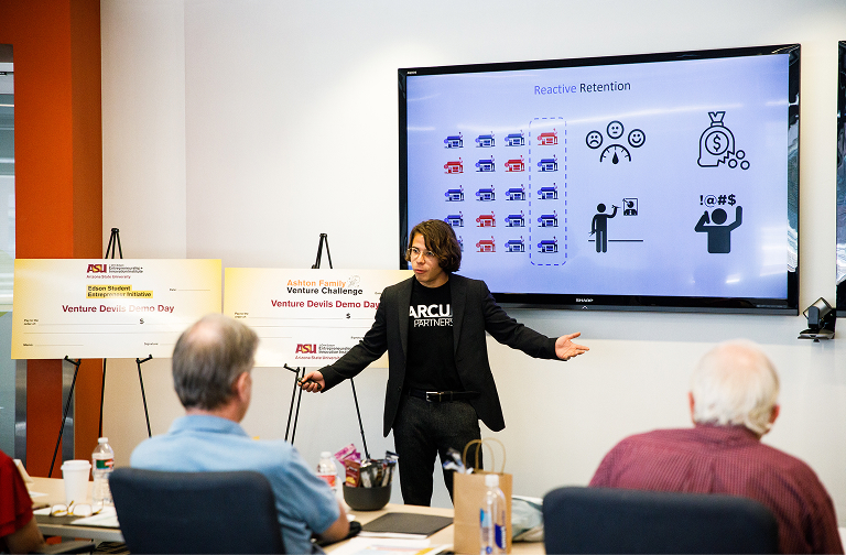 A startup founder presents a pitch to judges