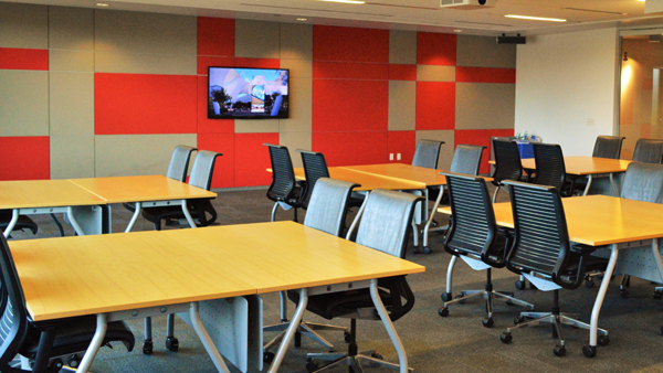 Global room close up of squares with monitor on wall.