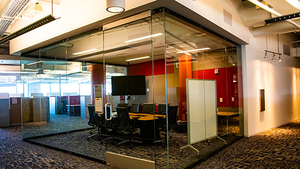 Endeavor boardroom view from hallway showing entire room enclosed with glass walls.