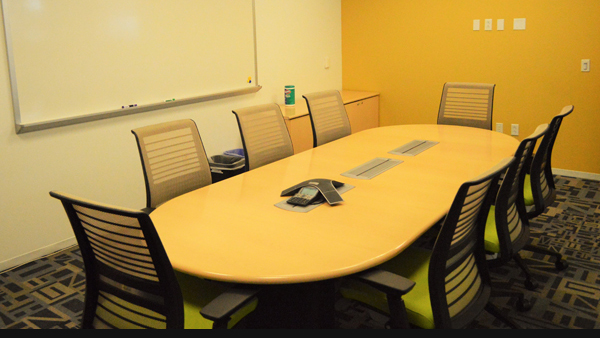 Acceleration board room conference table and chairs with speaker phone on table.