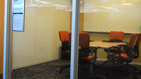 Collaboration room from hallway through glass door
