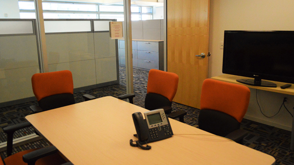 Confluence Room with phone in center of table