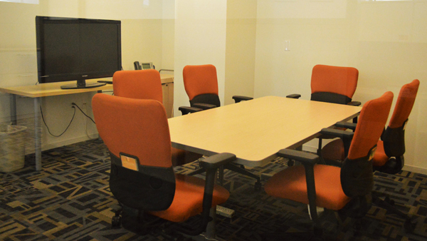Confluence room with table and six chairs