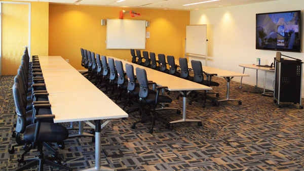 Discovery room tables with chairs on both sides of one table
