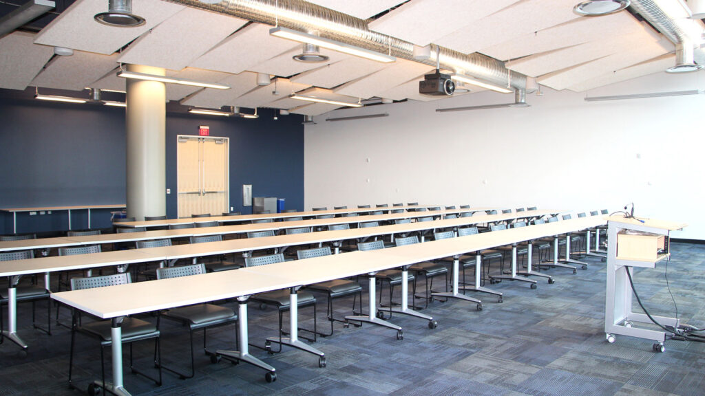 Synergy I room set up classroom style from front of room showing podium.