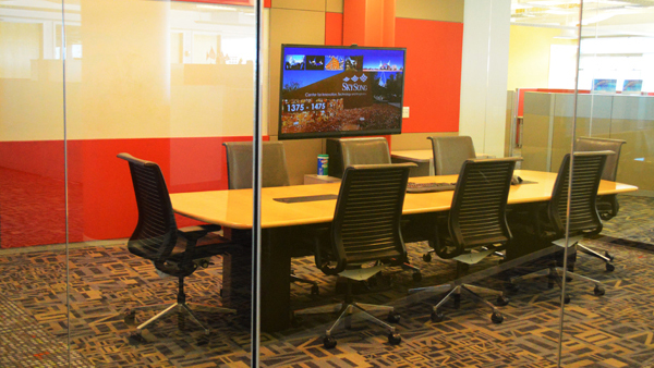 Vision room conference table and seating, with computer monitor to the side.